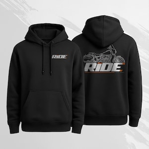 May include: Black hoodie with the word "RIDE" in silver and orange on the front. The back of the hoodie features a motorcycle outline with the word "RIDE" below it. The hoodie has a drawstring and a front pocket.