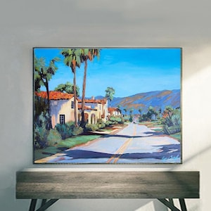 May include: An oil painting depicts a sunny street scene with a road leading towards the horizon. Palm trees and buildings with red tile roofs line the road. The sky is a bright blue, and mountains are visible in the background.