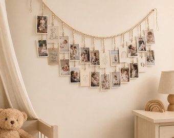 May include: A wall-mounted photo display garland featuring a long string of light-colored wooden beads. Numerous rectangular photo prints and illustrated cards are suspended from the beads by small wooden clips, creating a cascading arrangement.