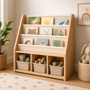 May include: A light wood children's bookshelf with three shelves and three storage bins. The shelves display illustrated books with animal and nature themes. The bins hold toys and blocks. A rug with colorful polka dots is in the foreground.