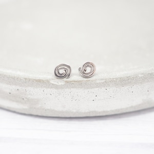 Pequeños pendientes de titanio en espiral: estilo bohemio minimalista e hipoalergénico.