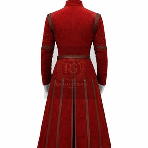 May include: A long, red quilted coat with brown leather accents and a matching belt. The coat features a high collar, decorative stitching, and vertical leather stripes on the skirt. The back of the coat is visible.