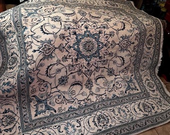 Handmade wool and silk Oriental rug with floral medallion design