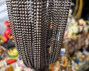 Beaded chandelier lamp shade with cascading strands of faceted beads
