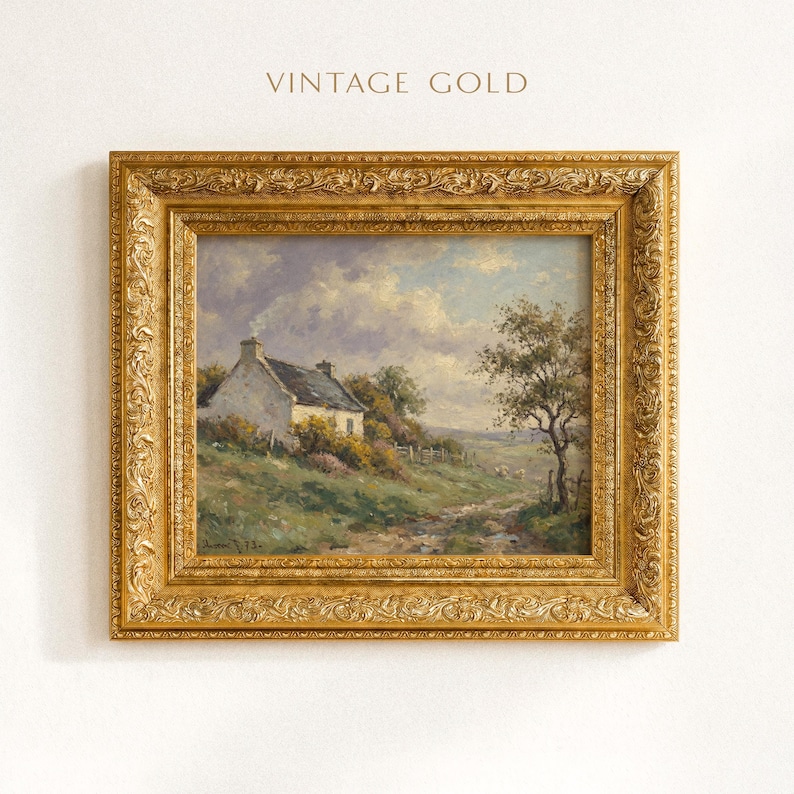 Vintage oil painting of a white stone cottage with a gray roof on a green hillside, surrounded by flowering bushes, a lone tree, and a dirt path under a cloudy sky, displayed in an ornate gold frame.
