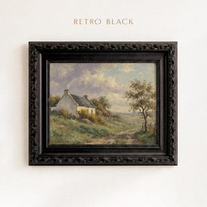 Vintage oil painting of a white stone cottage with a gray roof on a green hillside, surrounded by flowering bushes, a lone tree, and a dirt path under a cloudy sky, displayed in an ornate gold frame.
