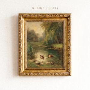 May include: A framed oil painting featuring a pond with two ducks swimming in the water, surrounded by green trees and reeds. The artwork is enclosed in an ornate, textured gold frame with the text RETRO GOLD printed above the frame.