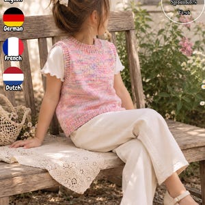 May include: A sleeveless knit vest featuring a multicolored speckled pattern in shades of pink, yellow, and blue. The garment has a ribbed crew neckline, ribbed armholes, and a ribbed hem. The vest is worn over a plain white short-sleeved shirt.