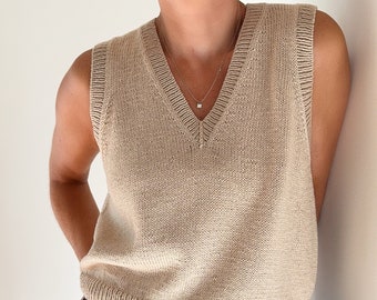 May include: A beige sleeveless knitted sweater vest with a v-neck.