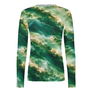 May include: A long-sleeve shirt featuring an abstract pattern of swirling deep forest green, emerald, and white tones that resemble ocean waves or marble textures. The garment has a crew neckline and fitted sleeves, displaying a continuous print.