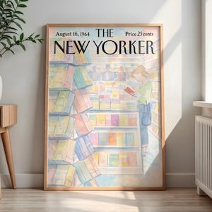 May include: A framed print of a New Yorker magazine cover from August 16, 1964. The illustration depicts a person reading in a bookstore, surrounded by colorful books. The frame is a light brown color.