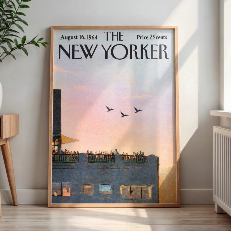 May include: A framed vintage New Yorker magazine cover from August 16, 1964. The artwork depicts a rooftop scene with people, birds in flight, and a sunset. The frame is a light brown color.