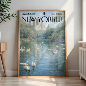 May include: Framed vintage New Yorker magazine cover from August 16, 1964, featuring a serene lake scene with swans and a distant cityscape. The artwork is in a wooden frame, adding a classic touch to the print.