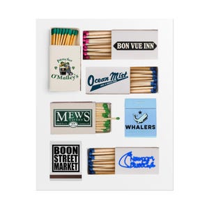 May include: A collection of matchboxes with various designs and text. The boxes feature logos for "Bon Vue Inn", "Ocean Mist", "Mews Tavern", "Whalers", "Boon Street Market", "Newport Bluescafe", and "Pancho O'Malley's". The matches have colored tips.