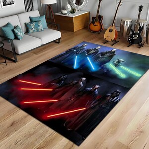 May include: A rectangular area rug featuring a Star Wars theme. The rug depicts characters with glowing lightsabers in blue, green, and red against a dark background. The rug is placed on a wooden floor.