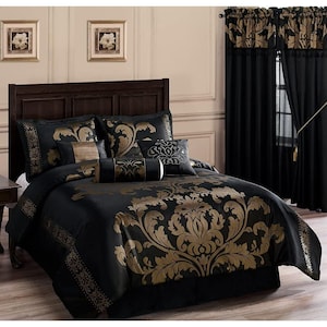 May include: A black and gold damask-patterned bedspread set. The set includes a comforter, pillows, and a bed skirt. The curtains in the background match the bedspread design. The headboard is dark brown.