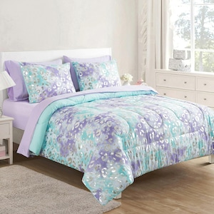 May include: A bed set featuring a comforter, two pillow shams, and a sheet set. The bedding has a purple, teal, and silver animal print design. The comforter and pillow shams have a quilted pattern. The sheets are solid lavender.