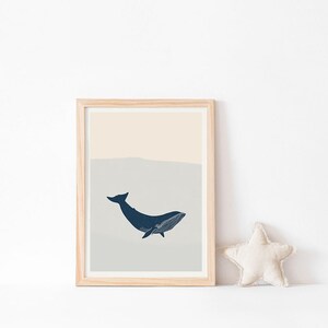 May include: A framed print of a blue whale with a light blue and beige background. The whale is swimming towards the right side of the image.