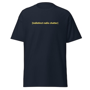 May include: Navy blue t-shirt with the text "[indistinct radio chatter]" in yellow. The shirt has short sleeves and a classic crew neck design. The text is centered on the chest.