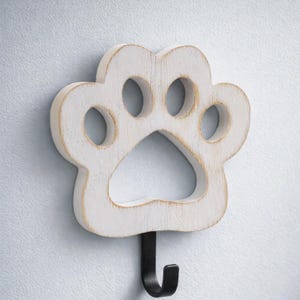 May include: A rustic wooden sign with the text "Welcome to our home" in white lettering. The sign features a distressed finish and a simple, inviting design, perfect for a front porch or entryway.