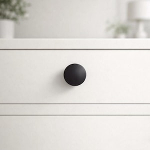 May include: A set of three ceramic mugs with a speckled, cream-colored glaze. Each mug features a different hand-painted floral design in shades of blue, green, and yellow. The mugs have a simple, rounded shape and a comfortable handle.