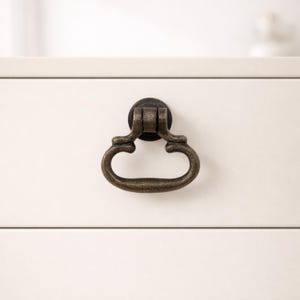 May include: A white ceramic mug with a black handle and the text "But First, Coffee" in a black, bold font. The mug is sitting on a wooden surface. The mug is approximately 4 inches tall.