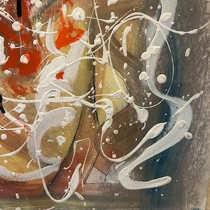 May include: Abstract painting with a mix of colors including orange, yellow, brown, and blue. White paint splatters and lines create a dynamic composition. The artwork is mounted on a white surface with a push pin.