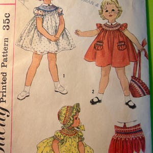 May include: Vintage Simplicity pattern featuring illustrations of children's dresses. The dresses are in various colors, including white with blue accents, orange, and yellow with floral prints. The pattern includes a skirt design.