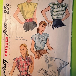 May include: Vintage Simplicity sewing pattern number 1867 for a blouse with a bow. The pattern is for a medium size and costs 25 cents. The pattern shows four different styles of blouses, including a striped blouse, a plaid blouse, and a solid color blouse.