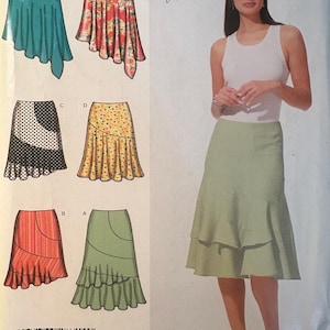 May include: A sewing pattern featuring various skirt designs. The designs include skirts in teal, floral, polka dot, and solid colors. The image also shows a woman wearing a light green skirt with a white tank top.