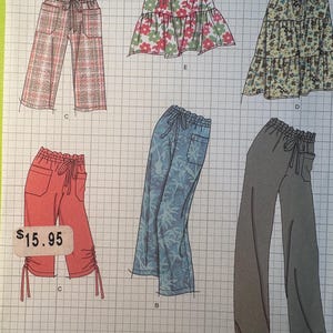 May include: A sewing pattern sheet featuring illustrations of various pants and skirts. Designs include a pair of plaid pants, a floral skirt, and a pair of capri pants. The price tag shows $15.95.