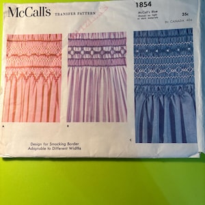 May include: A vintage McCall's transfer pattern for smocking borders. The pattern features three smocking designs in pink, purple, and blue, with the text "Design for Smocking Border Adaptable to Different Widths". The pattern is labeled "1854".