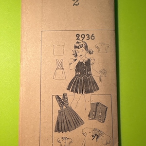 May include: Vintage sewing pattern envelope with the number "2" at the top. The pattern number "2936" is visible, along with illustrations of a girl's dress and other garment pieces. The envelope is tan with black text and illustrations.