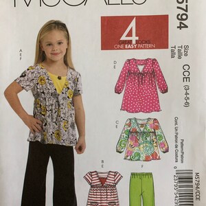 May include: Sewing pattern for a girl's dress and trousers. The pattern includes four different looks, all with a v-neck and a ruffle detail. The pattern is for sizes 3-4-5-6. The pattern is called McCall's M5794.