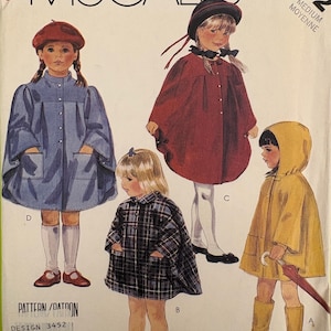 May include: McCall's sewing pattern with illustrations of children's coats and capes. The pattern includes a blue coat, a red cape, a plaid cape, and a yellow raincoat. The size is medium.