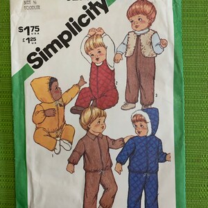 May include: Simplicity sewing pattern number 5258 for a toddler. The pattern includes instructions for making five different outfits: a yellow hooded jumpsuit, a blue hooded jumpsuit, a brown quilted jumpsuit, a brown quilted jacket and trousers, and a brown waistcoat and trousers. The pattern is priced at £1.25 UK and $1.75 USD.