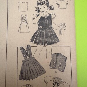 May include: Vintage sewing pattern featuring a young girl in a dress, with illustrations of different clothing items. The number "2936" is printed at the top. The dress has a pleated skirt and decorative accents.