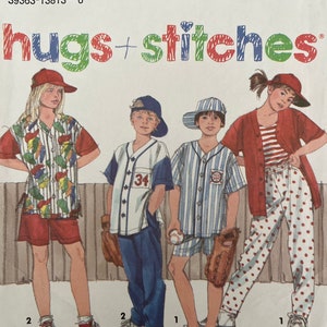 May include: A sewing pattern for children's clothing. The pattern includes instructions for making a short-sleeved shirt, a pair of shorts, and a pair of pants. The pattern is from Simplicity and is part of their "hugs + stitches" line.