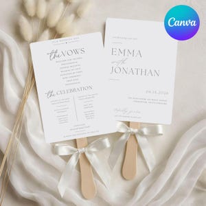 May include: Two white wedding program fans with black text, featuring the names Emma and Jonathan, the date 06.18.2026, and a detailed ceremony order. Each fan has a wooden handle and is tied with a white satin ribbon bow at the base.