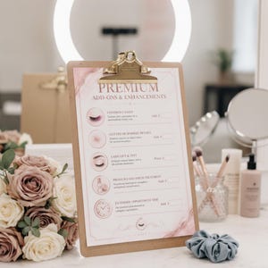 May include: A clipboard with a gold metal clip displaying a menu titled PREMIUM ADD-ONS & ENHANCEMENTS. The document features pink and gold marble accents, icons for lash services, and text listing options like colored lashes and lash lift and tint.