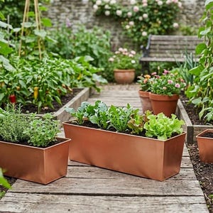 May include: A garden scene featuring copper rectangular planters filled with herbs and leafy greens. The planters sit on a wooden walkway, surrounded by other plants, flowers, and a bench in the background.