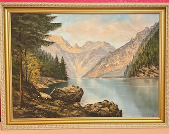 Cuadro al óleo vintage de los años 70: Pareja junto al lago en un paisaje boscoso. Firmado por “L Konig”. 25x33 cm.