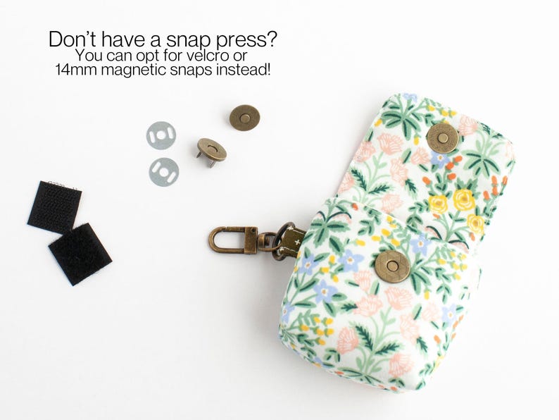 May include: A small, floral-patterned pouch with a metal clasp and magnetic snaps. The pouch is open, revealing its interior. Two pieces of velcro and two magnetic snaps are also visible. Text reads: "Don't have a snap press? You can opt for velcro or 14mm magnetic snaps instead!"