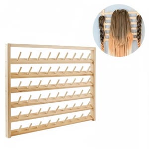 May include: A wooden hair extension rack with multiple rows of pegs for hanging hair extensions. The rack is made of light-coloured wood and has a rectangular frame. A circular inset shows hair extensions in various colours.
