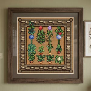 May include: A framed cross-stitch embroidery featuring a grid of various stylized plants and flowers in shades of green, red, purple, and blue, set against a tan background within a dark brown wooden frame with a wide matting border.
