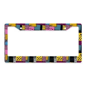 May include: A rectangular license plate frame featuring a colorful patchwork pattern of yellow, blue, pink, and black squares. The design includes various graphic textures such as polka dots, swirling lines, and stripes across the entire border.