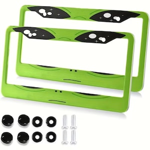 May include: Two green license plate frames with a cartoon character design. The frames have black accents and come with mounting hardware, including screws, washers, and black screw caps. The frames are designed to fit standard U.S. license plates.