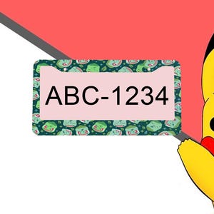 May include: A rectangular license plate frame featuring a dark green repeating pattern of Bulbasaur characters. The center of the frame is light pink and displays the black text ABC-1234. A portion of a yellow character is visible on the right side.