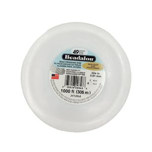 May include: A spool of Beadalon bead stringing wire, gold color, in a white plastic container. The label indicates 1000 ft (305 m) of wire, with a diameter of .024 inches (0.61 mm). The product is designed for jewelry making.