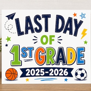May include: A white sign with the text "LAST DAY OF 1ST GRADE 2025-2026" in blue, green, orange, and yellow. The sign includes illustrations of a basketball, soccer ball, stars, and a paper airplane.